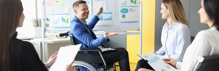 Support team meeting with a participant in a wheelchair