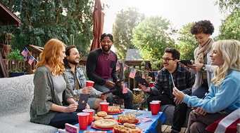 Group enjoying a social BBQ lunch outdoors