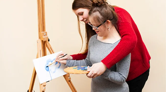 Participant working on a drawing with support worker guidance