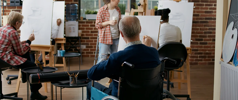 Participants drawing at easels in a group art workshop